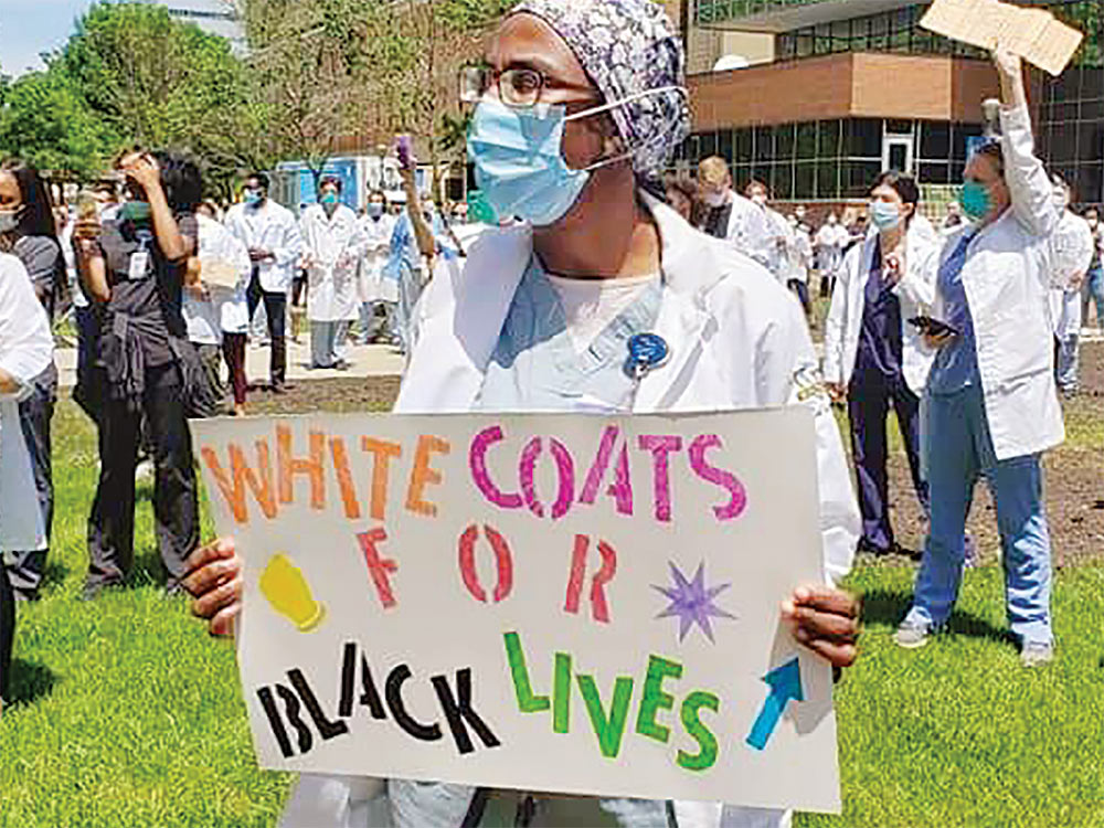 Women holds sign at Black Lives Matter protest