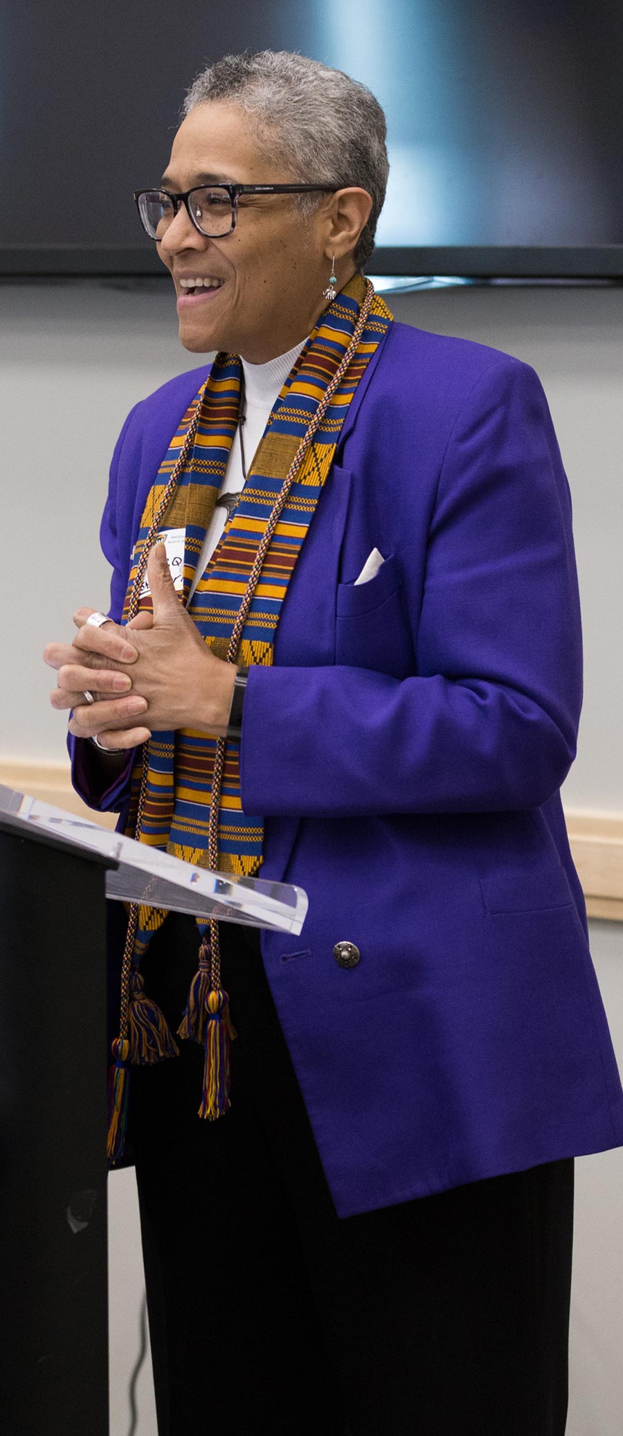 Marquita Chamblee stands at a podium, mid speech