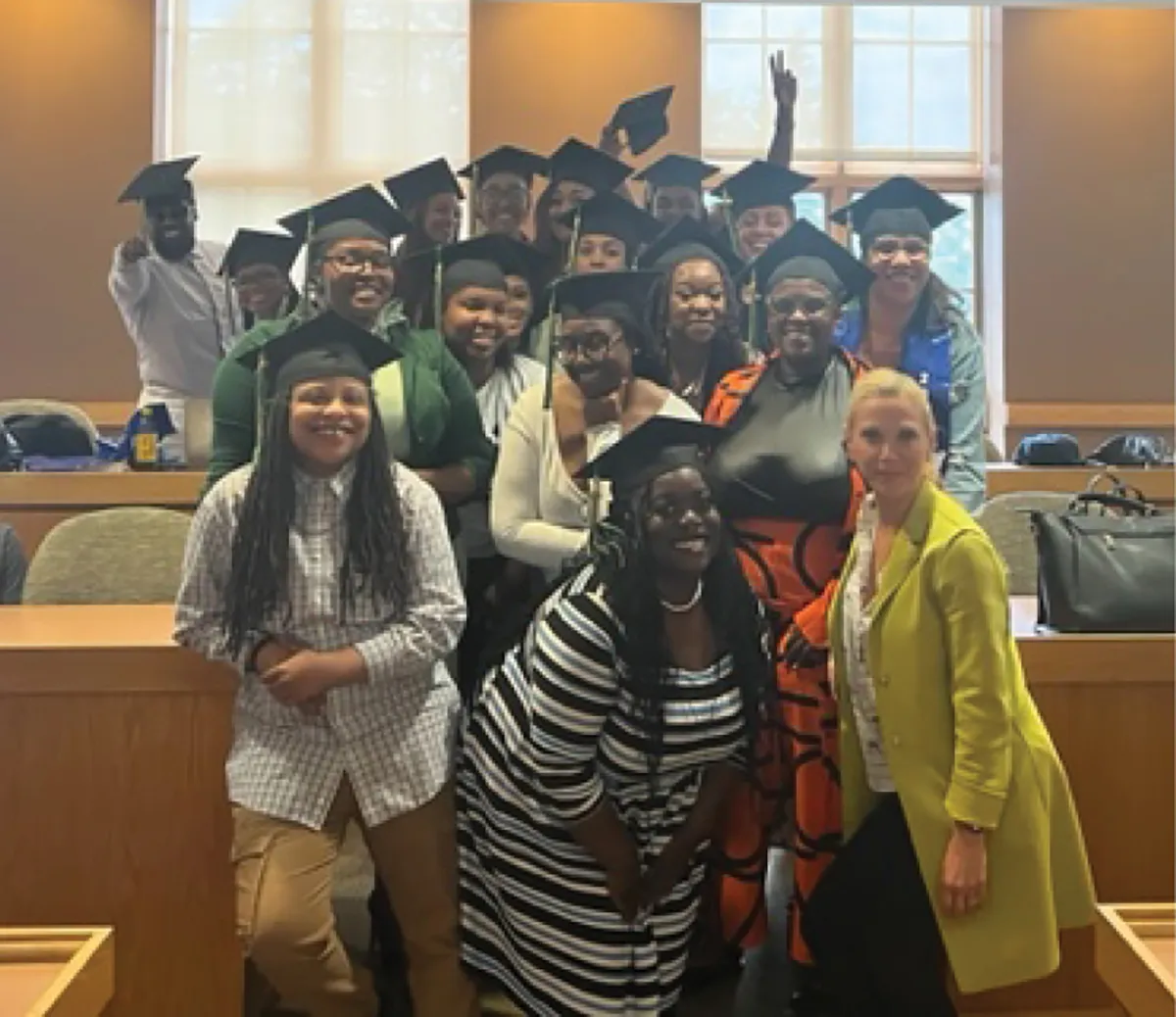 smiling students in graduation caps